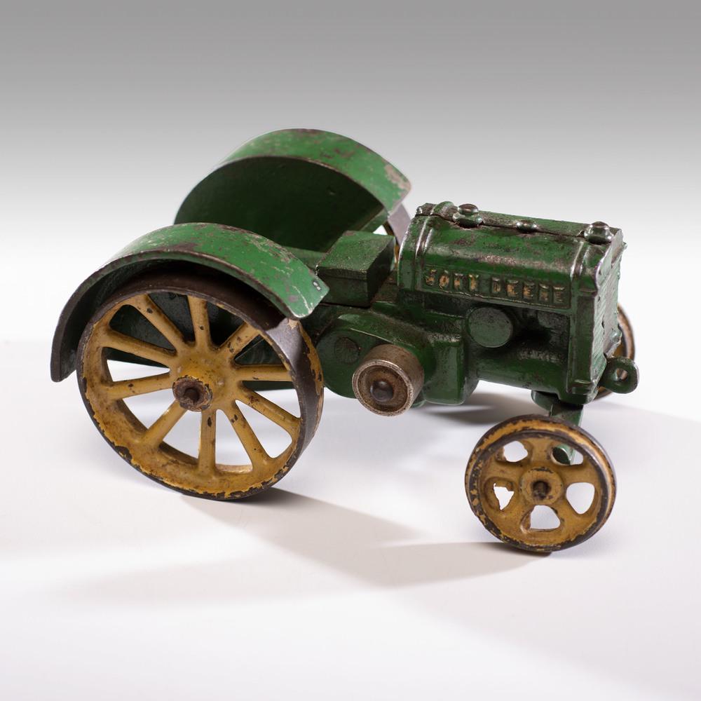 A Vindex Cast Iron John Deere Tractor: A Vindex Cast Iron John Deere Tractor Length 6 inches.