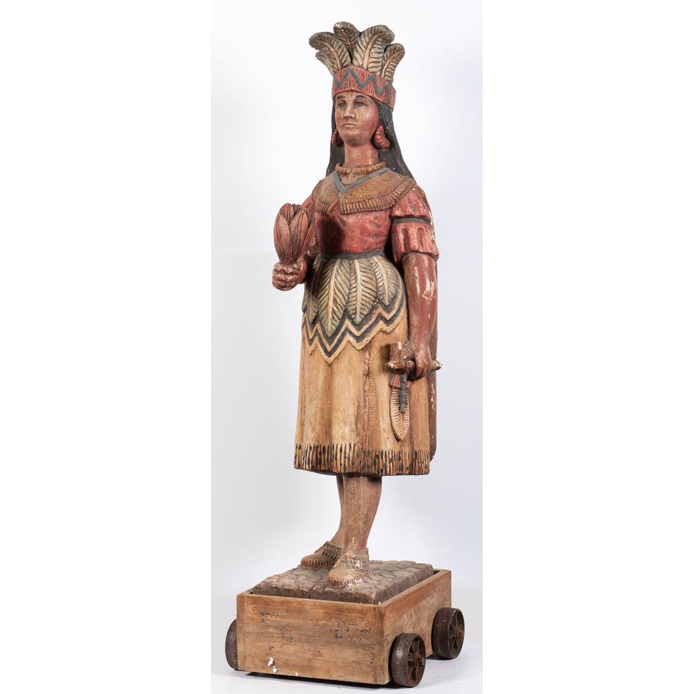 A Painted Wood & Plaster Cigar Store Indian by: A Painted Wood & Plaster Cigar Store Indian by Josephine Mead (American, 1919-2000) Mid-20th Century signed Jo Mead on base. on a rolling box base. Height 76 inches.