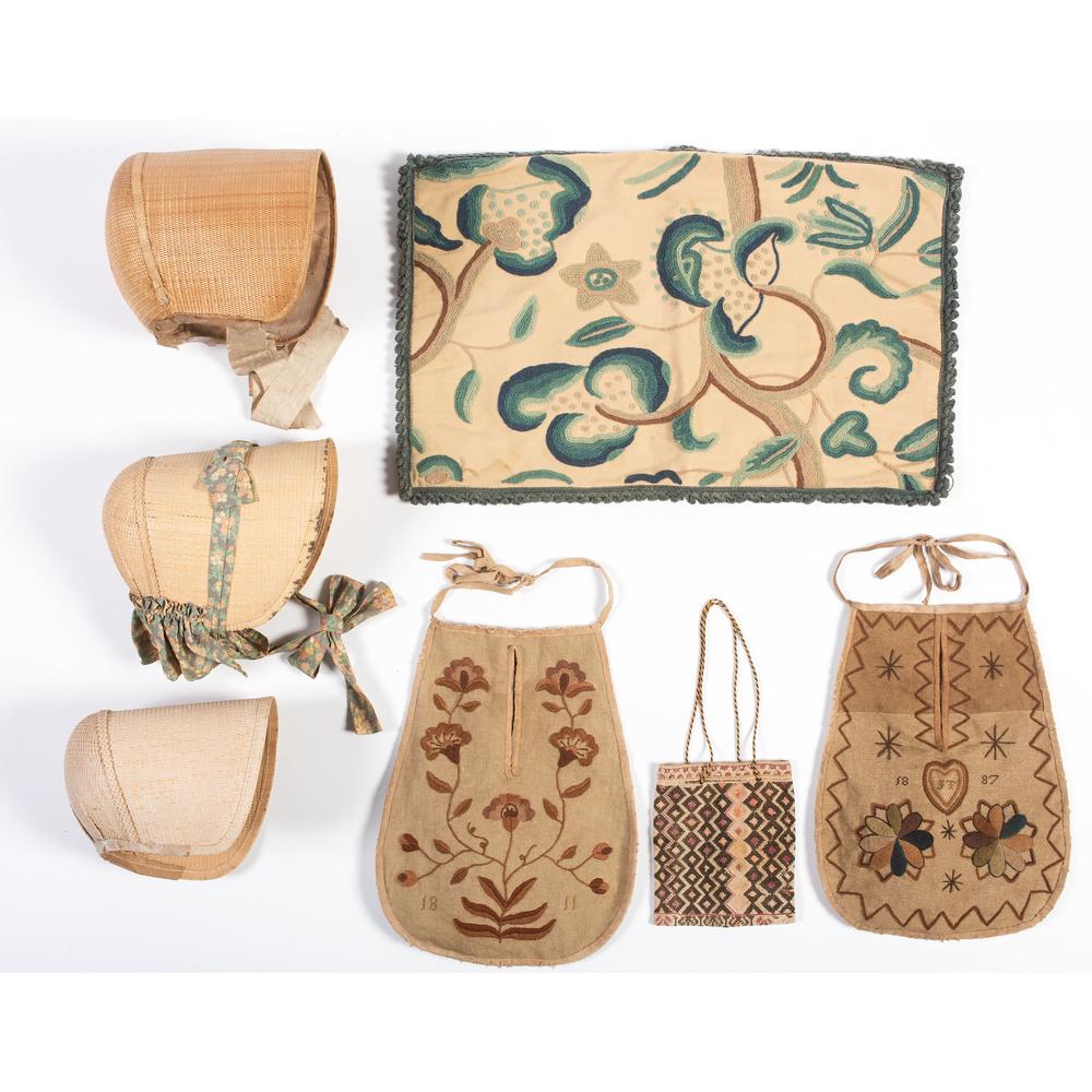 Two Embroidered Aprons, A Purse, and A Pillow Cover: Two Embroidered Aprons, A Purse, and A Pillow Cover 19th/20th Century together with three bonnets. Pillow cover 23 1/2 x 15 inches Provenance: Property from the Collection of Judith & Gary Gay, Morrow