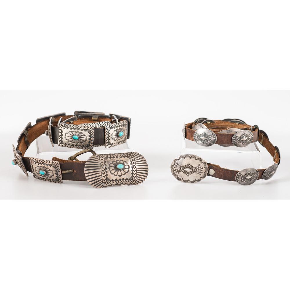 Navajo and Kewa Concha Belts: lot of 2, includes a stamped concha belt with twenty oval conchas and a matching buckle; marked CRZ for Herb Coriz (Kewa, 20th century), belt length 48 in., concha length 1 in. x width 0.75 in., buckl