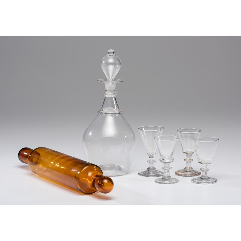 A Blown Glass Decanter with Sherry Glasses, Plus: A Blown Glass Decanter with Sherry Glasses, Plus American, 19th/20th Century includes one decanter and four glasses, plus a blown amber glass rolling pin. Height of decanter 11 1/2 inches, length of r