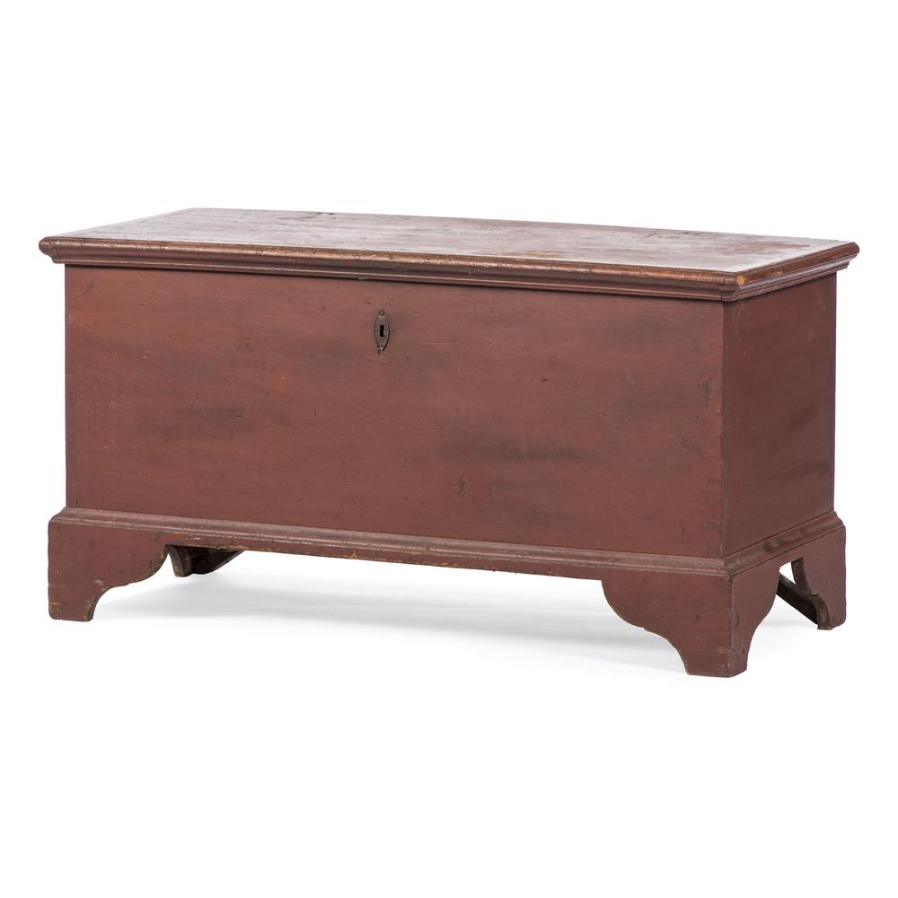 A Painted Blanket Chest: A Painted Blanket Chest American, 19th Century in red paint and with a dovetailed case. Height 26 x width 50 x depth 22 inches.