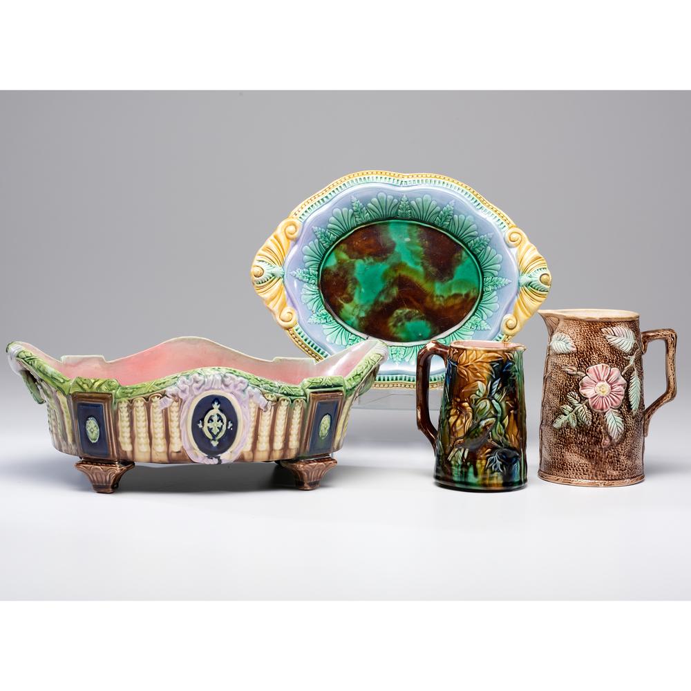Four Majolica Tablewares: Four Majolica Tablewares 19th Century including two pitchers and two dishes. Length of largest dish 16 1/2 inches; height of tallest pitcher 7 1/2 inches.