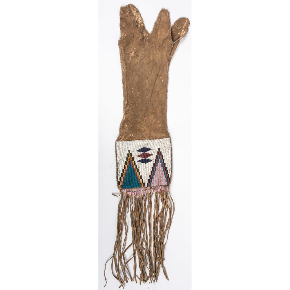 Blackfoot Beaded Hide Tobacco Bag: Blackfoot Beaded Hide Tobacco Bag thread-sewn softly tanned hide; with lower panel beaded using colors of white, pony trader blue, red white-heart, greasy yellow, cobalt, rose, pink, and black; throat