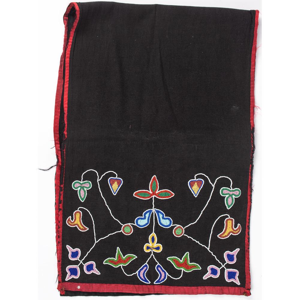 Ho Chunk Beaded Dance Apron: thread-sewn and beaded using colors of white, pink, greasy yellow, apple red white-heart, maroon, and dark and light blue; floral designs on black polished cotton panels; edged with red sateen, length