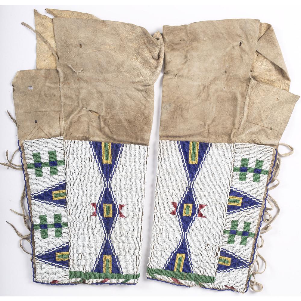 Sioux Beaded Hide Leggings, From the Stanley B. Slocum: Sioux Beaded Hide Leggings, From the Stanley B. Slocum Collection, Minnesota sinew-sewn and beaded using white, red white-heart, pea green and blue; with hide thong ties, length 17 in. late 19th centu