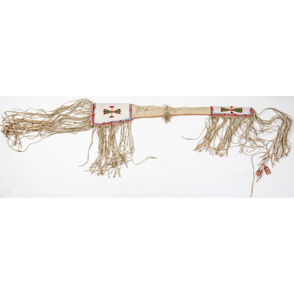 Northern Plains Beaded Hide Rifle Scabbard: Northern Plains Beaded Hide Rifle Scabbard thread-sewn and beaded using colors of red, greasy yellow, pea green, white, and light blue; long fringe falls from both ends of scabbard; lower edge trimmed