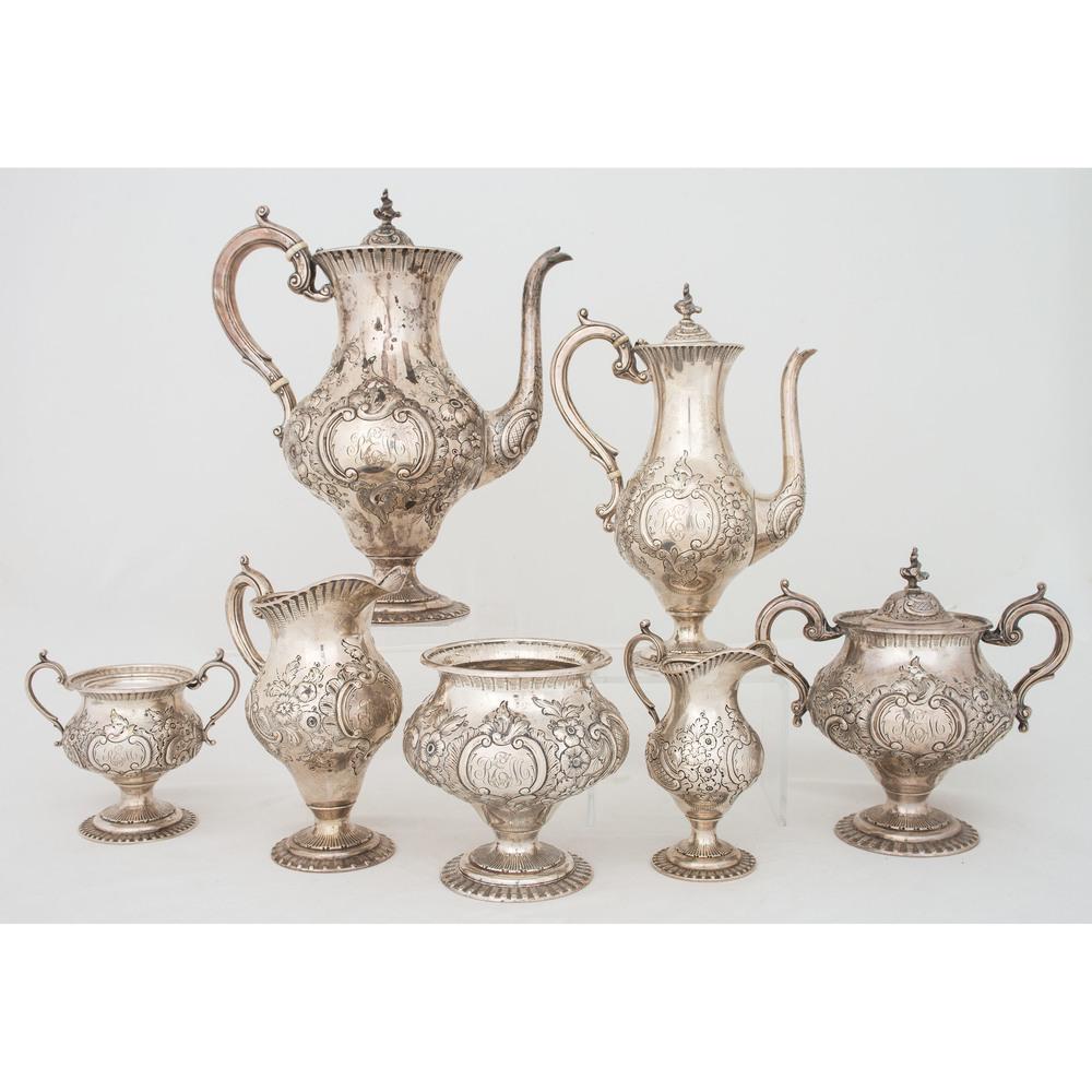 A Loring Andrews Repoussé Silver Coffee and Tea Service: A Loring Andrews Repoussé Silver Coffee and Tea Service American (Cincinnati), Early 20th Century a seven-piece service comprising a coffee pot, tea pot, two covered sugar bowls, two creamers and was