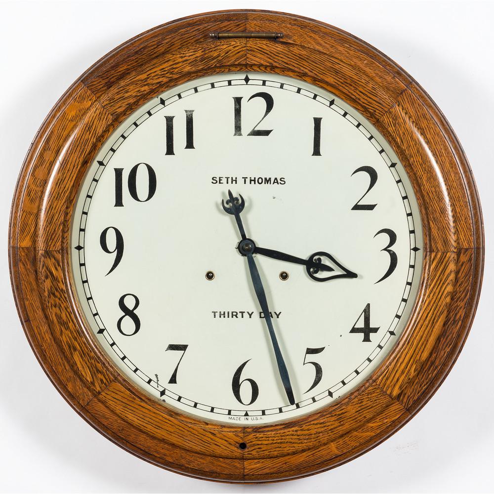 A Seth Thomas Oak Thirty Day Gallery Clock: A Seth Thomas Oak Thirty Day Gallery Clock Early 20th Century Diameter 24 inches.