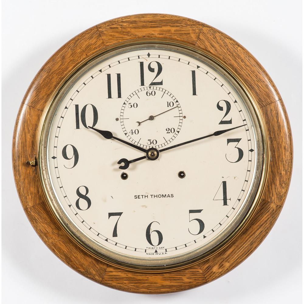 A Seth Thomas Thirty Day Brass and Oak Gallery Clock: A Seth Thomas Thirty Day Brass and Oak Gallery Clock Early 20th Century Diameter 18 inches.