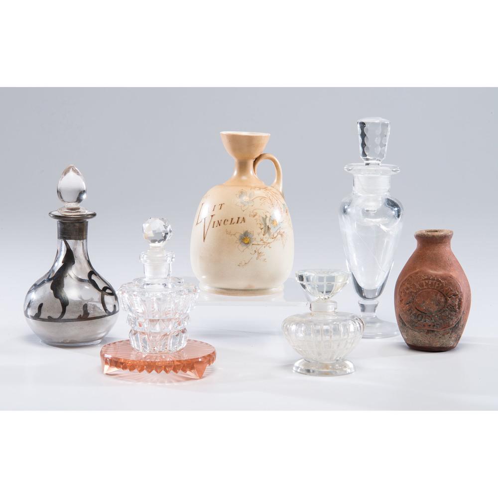 A Group of Glass and Ceramic Perfume Bottles: A Group of Glass and Ceramic Perfume Bottles 19th/20th Century including four glass bottles, a small redware bottle with partially legible impression reading Fragrance, and a Blondeau Et Cie miniature
