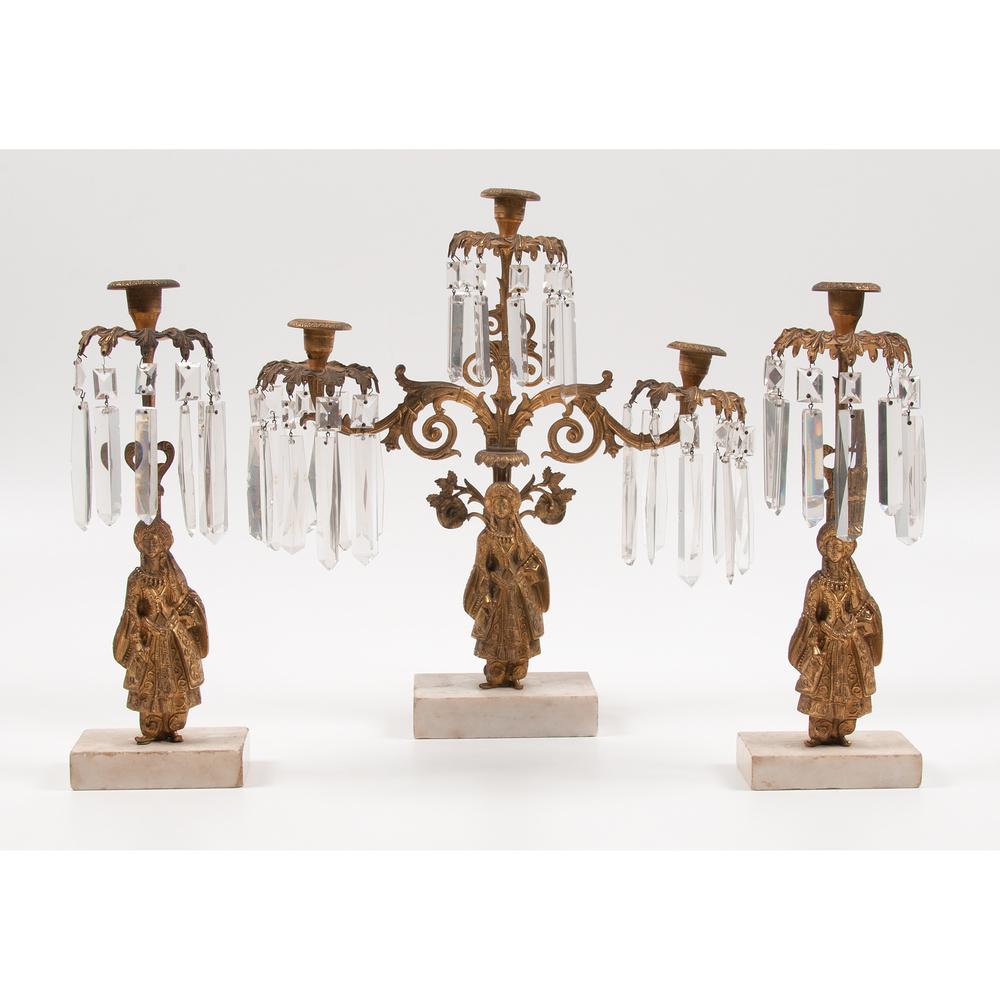 A Gilt Metal Girandole Garniture Set: A Gilt Metal Girandole Garniture Set American, 19th Century a three-piece figural gilt metal girandole garniture set Height of largest 17 1/2 x width 16 x depth 4 1/2 inches.