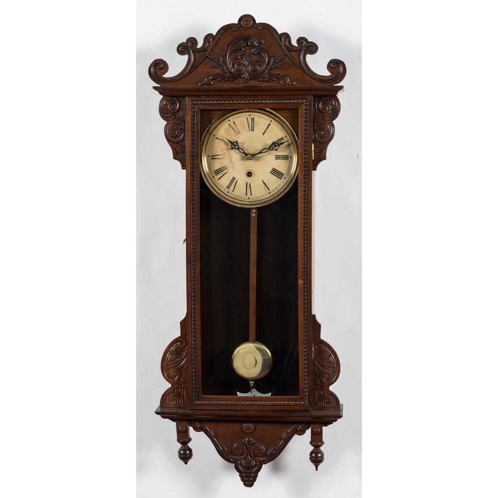 Two Waterbury Clock Co. Regulator Clocks: Two Waterbury Clock Co. Regulator Clocks Early 20th Century Height of larger 39 x width 15 1/2 inches.