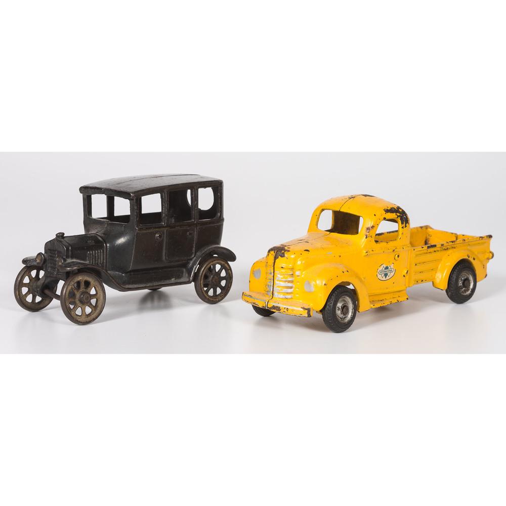 Two Cast Iron Toy Cars, Arcade & International: Two Cast Iron Toy Cars, Arcade & International 20th Century Height of truck 3 3/8 x length 9 1/4 inches. Height of car 3 7/8 x length 6 3/8 inches.