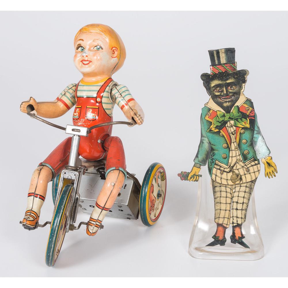 A Group of Tin Lithographed Toys: A Group of Tin Lithographed Toys Late 19th/20th Century includes a wind-up automated child on tricycle with a bell along with a Tin Man (limbs and face move when hat is pushed/pulled). Largest height 