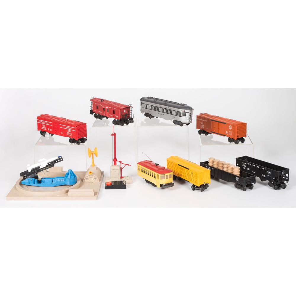 A Group of Nine Lionel Cars and Accessories, Most in: A Group of Nine Lionel Cars and Accessories, Most in Original Boxes 20th Century including No. 2433 Illuminated Observation Car, No. 60 Trolley, No. 6517 Caboose, No. 6456 Hopper Car, No. 6462 Gondola