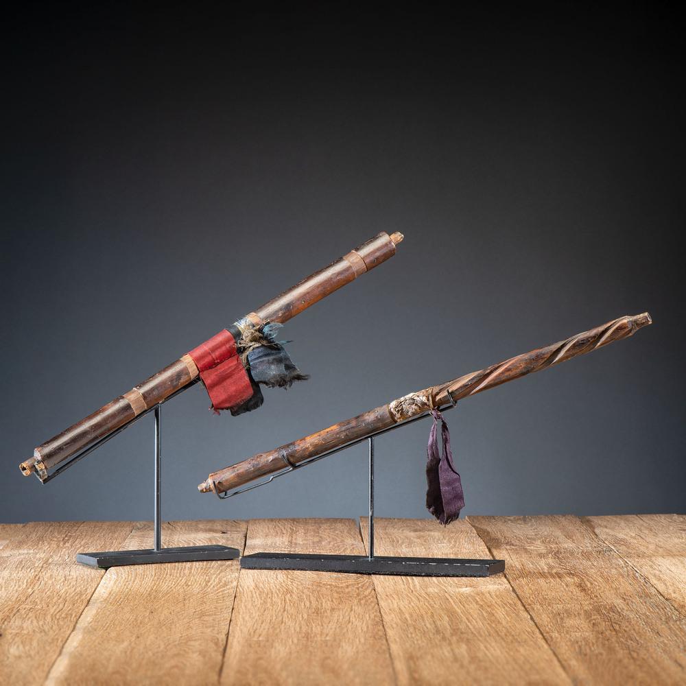 Western Great Lakes Wood Pipe Stems, From the Stanley: Western Great Lakes Wood Pipe Stems, From the Stanley B. Slocum Collection, Minnesota lot of two, includes one having a deep patina and decorated with red, blue, and black silk ribbons, length 18.5 in