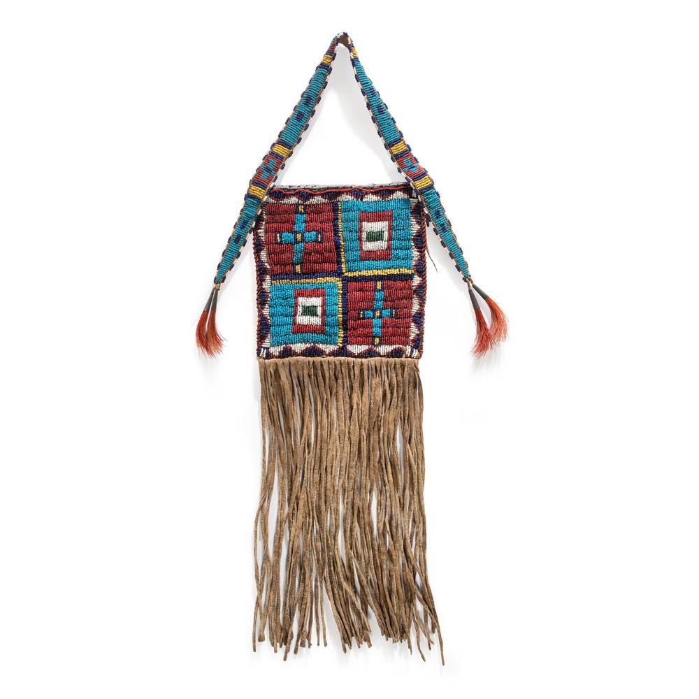 Sioux Beaded Hide Bag: Sioux Beaded Hide Bag sinew-sewn and beaded in colors of red white-heart, light and dark blue, white, translucent green, and greasy yellow; bag is finished with long hide fringe, overall length 22 in.