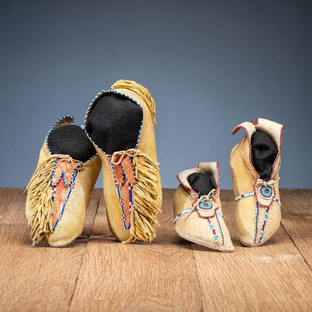 Southern Plains Child's Beaded Hide Moccasins: Southern Plains Child's Beaded Hide Moccasins lot of 2, both thread-sewn and made of softly tanned hide; includes a pair made from soft hide; yellow pigment and red pigment; beaded lanes decorate the