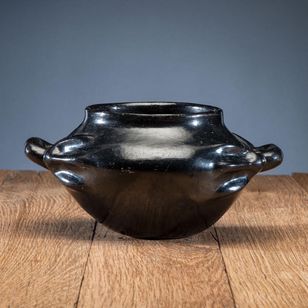 Sara Fina Tafoya (Santa Clara, 1863-1949), Attributed: Sara Fina Tafoya (Santa Clara, 1863-1949), Attributed Blackware Pottery Bowl with high polish finish; rectangular handles with ends transforming into a hand, height 5.25 in. x diameter 10.25 in.. seco