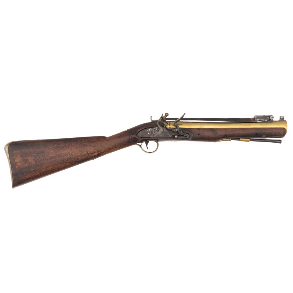 English Flintlock Blunderbuss By John & George Jones: 1" bore diameter, 11.75" brass barrel with folding bayonet, Lockplate marked John & Geo Jones. Brass furniture and walnut stock.