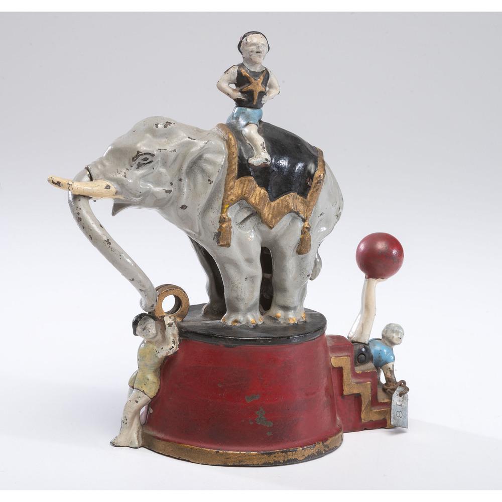 An Elephant and Three Clowns Cast Iron Mechanical Bank: American, 19th Century manufactured by J & E Stevens. patent date Aug 8, 1892 on underside. Height 6 inches.
