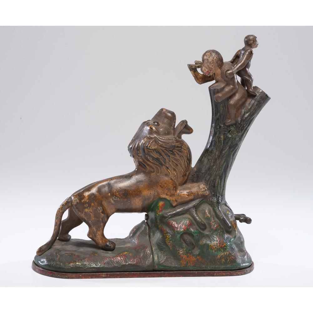 A Lion and Monkeys Cast Iron Mechanical Bank: American, Late 19th Century manufactured by Kyser & Rex. with 1883 patent on underside. Height 9 x length 9 inches.
