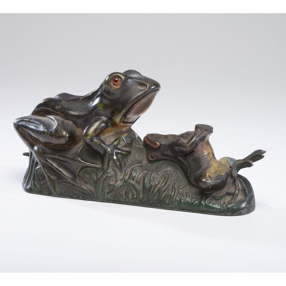 A Two Frogs Cast Iron Mechanical Bank, Plus: American, 19th Century manufactured by J & E Stevens. lot includes the 1940 book Old Mechanical Banks by Ina Hayward Bellows. Height 4 1/4 x length 9 inches.