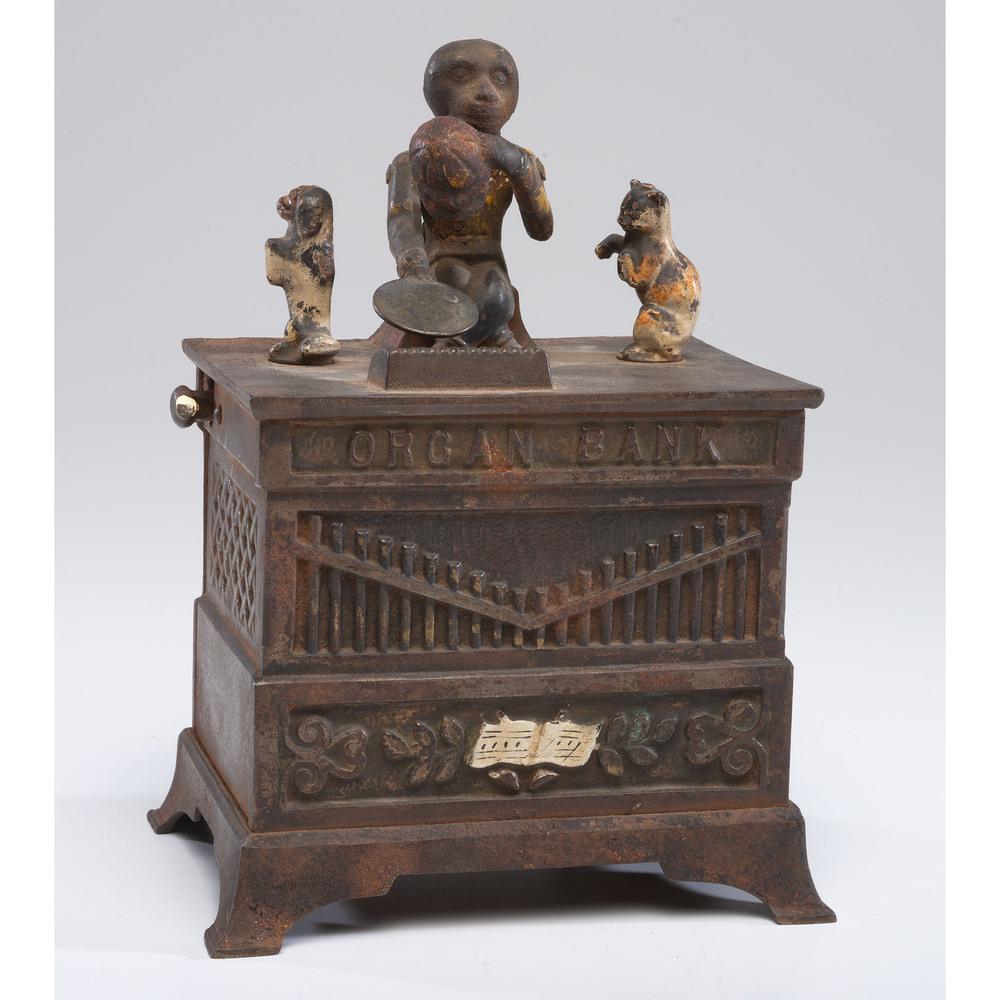 A Cast Iron Mechanical Organ Bank: American, 19th Century manufactured by Kyser & Rex. patent date June 13, 1882 on underside. Height 7 1/2 x width 5 1/2 inches.