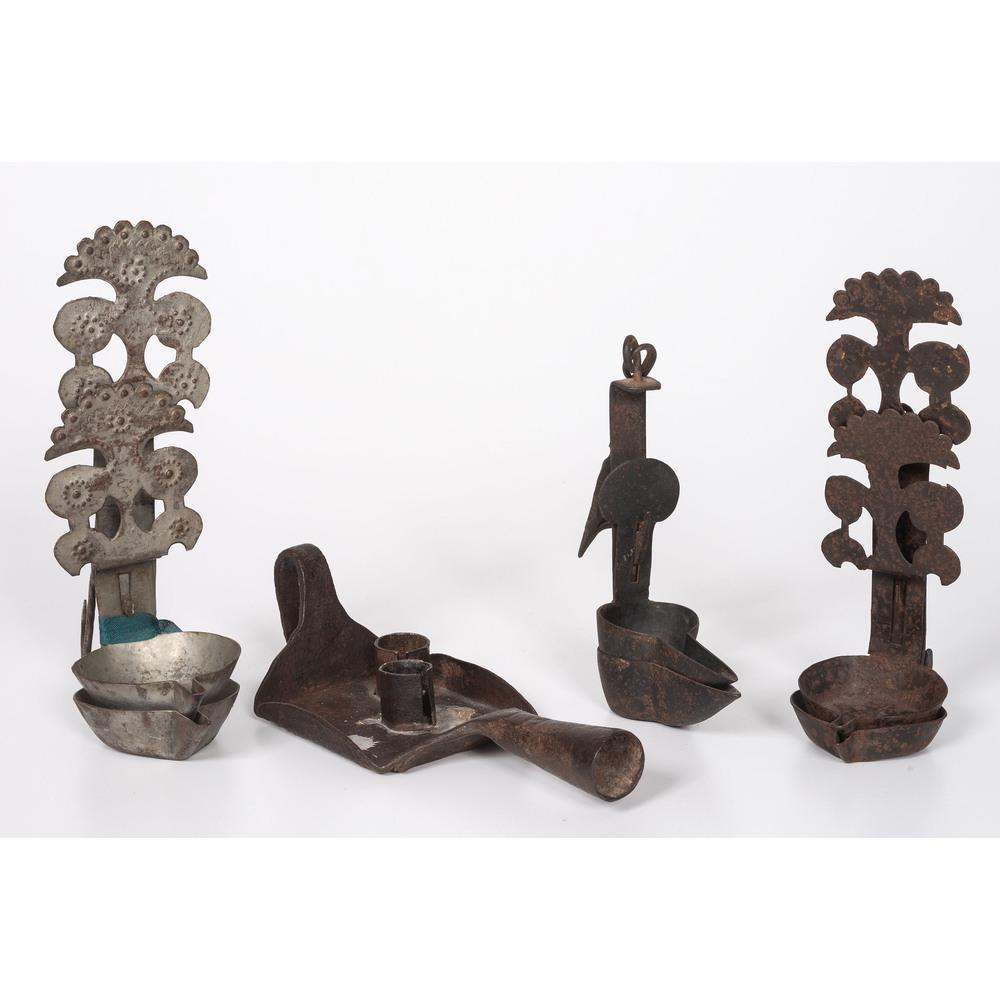 Three Iron Betty Lamps and A Chamberstick: American, 18th/19th Century Height of largest 9 1/2 inches. Provenance: Property from the Collection of Judith & Gary Gay, Morrow, Ohio