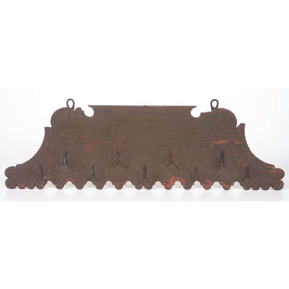 A Pine and Wrought Iron Hanging Meat Rack in Old Paint: Height 9 x length 29 1/2 inches. Provenance: Property from the Collection of Judith & Gary Gay, Morrow, Ohio