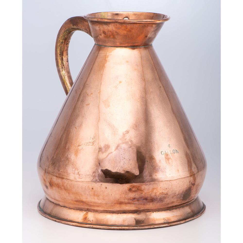 A Four Gallon English Copper Haystack Measure: 19th Century dovetailed under handle. labeled on front and with lead seal to interior marked with a crown, 386, LCC (London County Council), and 22. Height 16 1/2 inches. Provenance: Property from