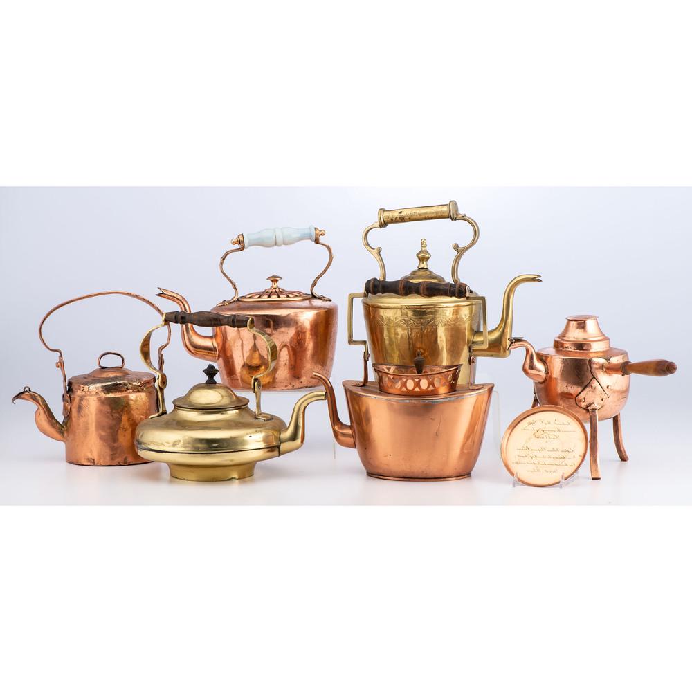 A Group of Copper and Brass Kettles: 19th Century includes two brass kettles, four copper kettles, and one presentation plate. Height of largest 11 1/4 inches.