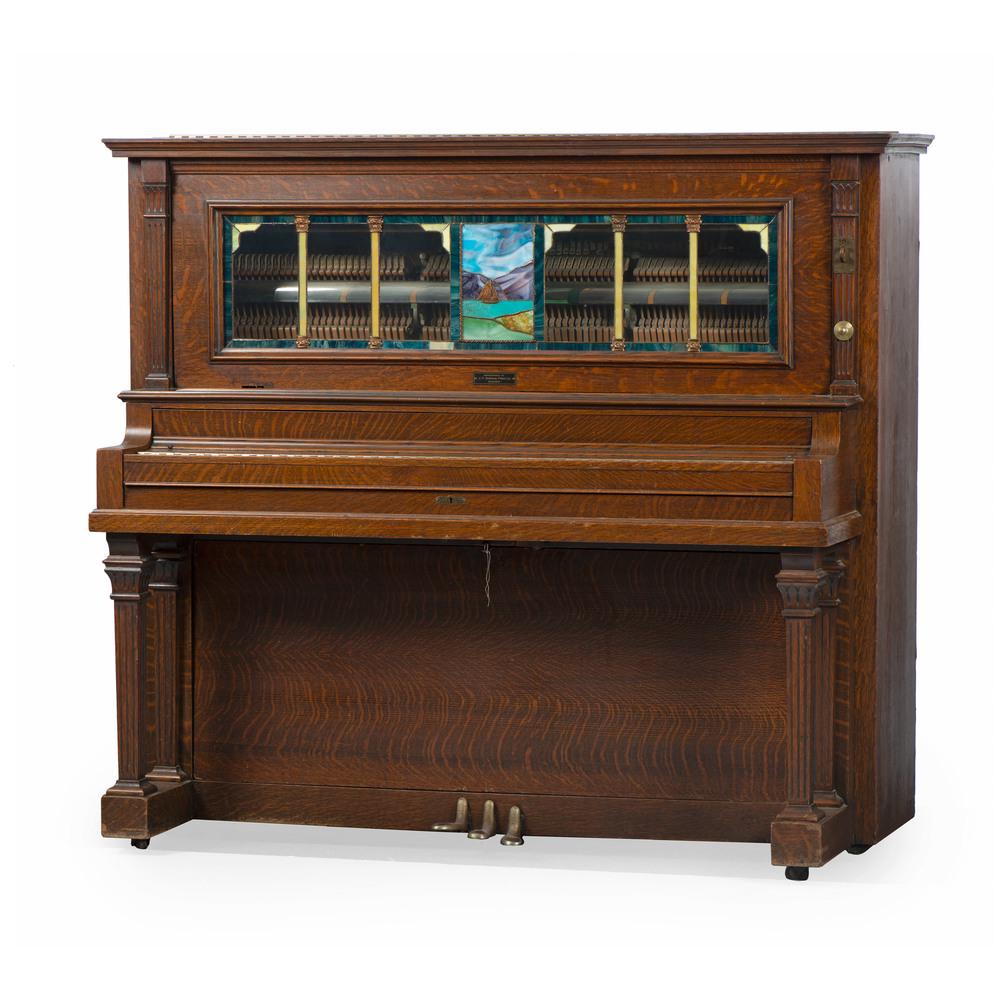 A Stain-Glass Mounted Figured Oak Coin-Operated Player: A Victorian Walnut Occasional Table with Micro Mosaic Top J.P. Seeburg Piano Co., Chicago, Circa 1910 Height 56 3/4 x width 64 1/4 x depth 28 1/4 inches. This lot is accompanied by a newspaper clippin