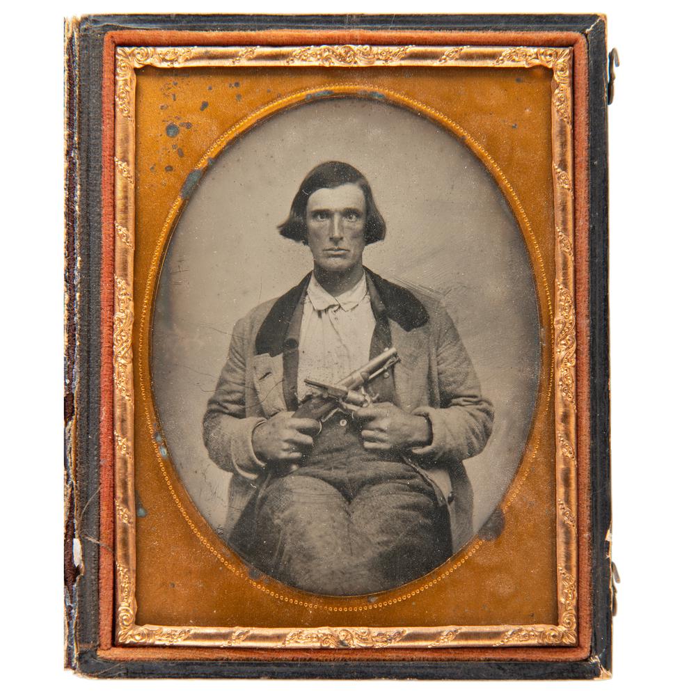 Quarter Plate Ambrotype of Double-Armed Gent, Possibly: Quarter plate ambrotype of a man with a slow eye and greased down hair displaying his 1842 single-shot percussion pistol and 1849 Colt percussion revolver. A great character study of a subject that ha