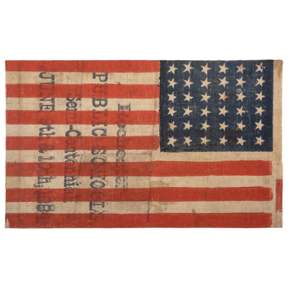 36-Star Rochester Schools American Flag: Printed flag on glazed cotton muslin, 5.25 x 9.5 in. Stamped overprint: "Rochester Public Schools Semi-Centennial June 9th & 10th, 1884." Ca 1884. The Rochester public school system was organized in 1