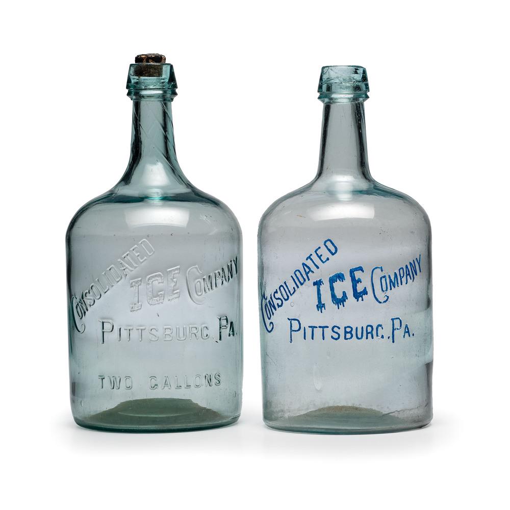 Two Consolidated Ice Company Molded Glass Two-Gallon: Two Consolidated Ice Company Molded Glass Two-Gallon Bottles Pittsburgh, Pennsylvania, late 19th/early 20th Century Height 16 3/4 inches.