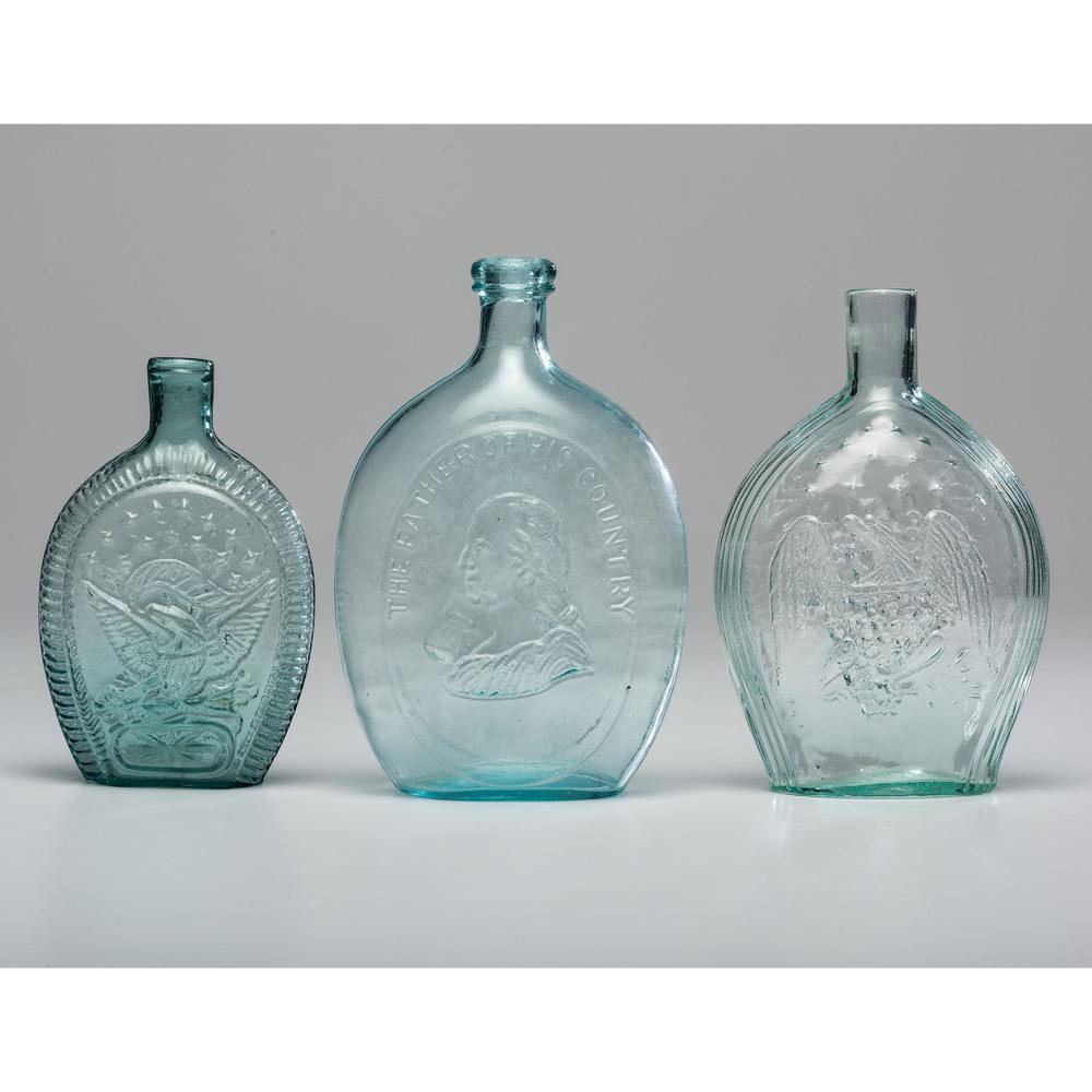 Three American Aqua Glass Flasks: Three American Aqua Glass Flasks 19th Century including a Father of His Country flask and two eagle and stars Union flasks. Height of largest 8 3/4 inches.