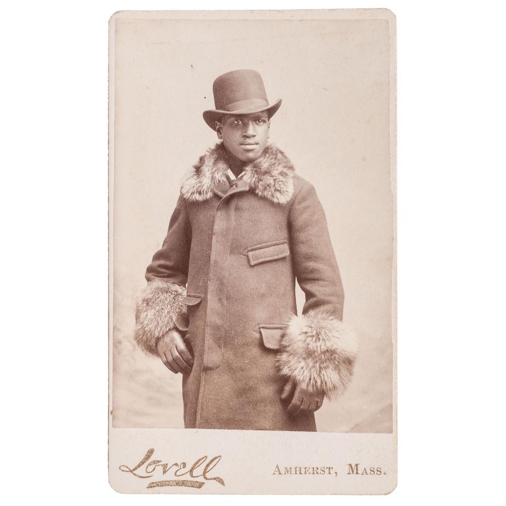 CDV of Well-Dressed African American Man by Lovell,: CDV standing portrait of an unidentified African American gentleman wearing a fur-lined coat and top hat. Lovell: Amherst, Massachusetts, n.d., circa 1870. Imprint on recto. John Lyman Lovell (1825-