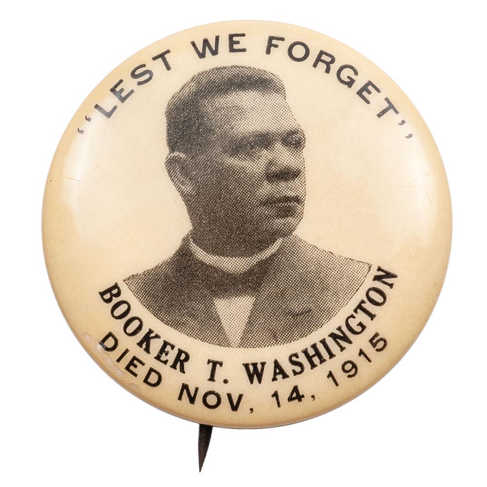 Booker T. Washington Memorial Pinback, 1915: Booker T. Washington pinback button. Caption "'Lest We Forget' / Booker T. Washington / Died Nov. 14, 1915" surrounds photographic image of Washington. Back paper with identification "Western Badge