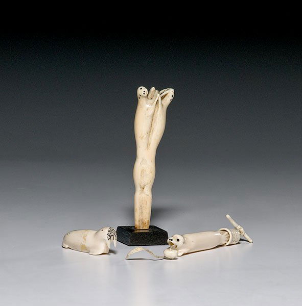 Eskimo Carved Ivory Figures, : Eskimo Carved Ivory Figures, early 20th century lot of 3; includes a needle case with thimble; baleen forms seal's eyes, length 6"; PLUS an umbrella handle carved with seal and walrus, length 5.75";