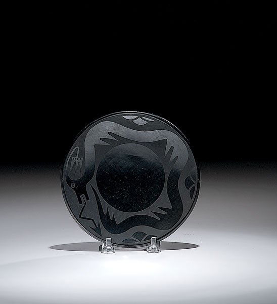 San Ildefonso Blackware Plate by Maria and Santana: San Ildefonso Blackware Plate by Maria and Santana Martinez, 1943 - 1954 with Avanyu slithering around a central sphere; signed Marie and Santana, diameter 6".