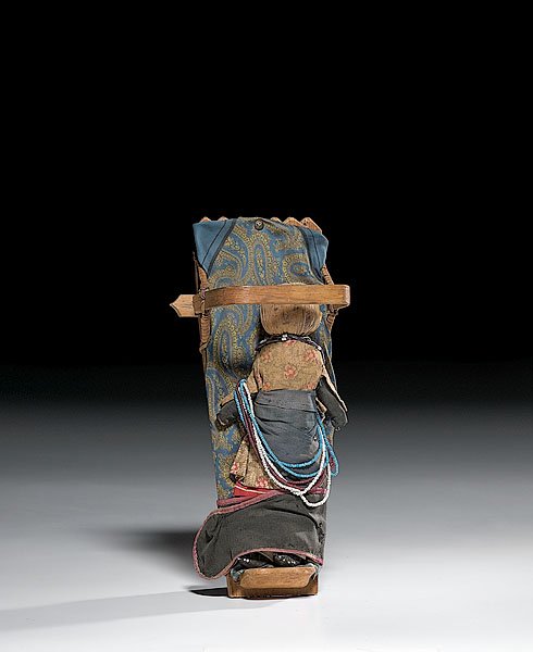 Onondaga Doll Cradle with Doll, : Onondaga Doll Cradle with Doll, early 20th century bentwood frame with scalloped top; calico silk scarf padding on which a corn husk doll rests; doll with inked facial features, beaded moccasins, an
