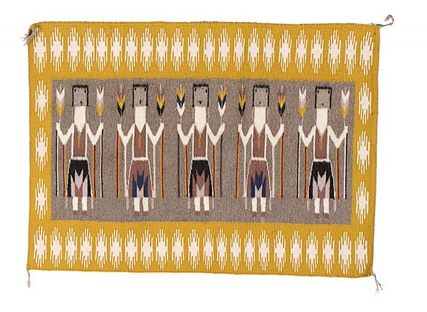 Navajo Yei Weaving by Antoinette Tsosie, : Navajo Yei Weaving by Antoinette Tsosie, contemporary with five Yei figures bordered by squash blossoms; Heard Museum Shop label noting weaver and pattern, 26" x 37".