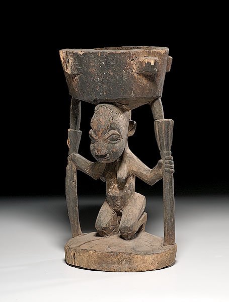 Yoruba Divination Bowl, : Yoruba Divination Bowl, 20th century created in traditional style with bowl balanced on head of kneeling woman with protruding breasts and outstretched arms, height 16.5" x diameter of base 8.25". 