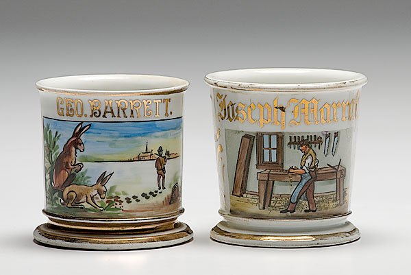 Two Occupational Shaving Mugs, Hunter and Carpenter: Two Occupational Shaving Mugs, Hunter and Carpenter, lot of two porcelain mugs with polychrome painted scenes. First depicts a carpenter at workbench with various tools on wall. Gilt name Joseph Mar