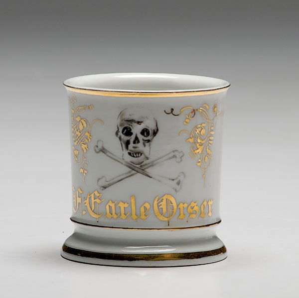 Doctor's Occupational Shaving Mug, : Doctor's Occupational Shaving Mug, porcelain, with polychrome painted scene of skull and crossbones. Gilt name H. Carle Orser with unknown German maker's mark.
