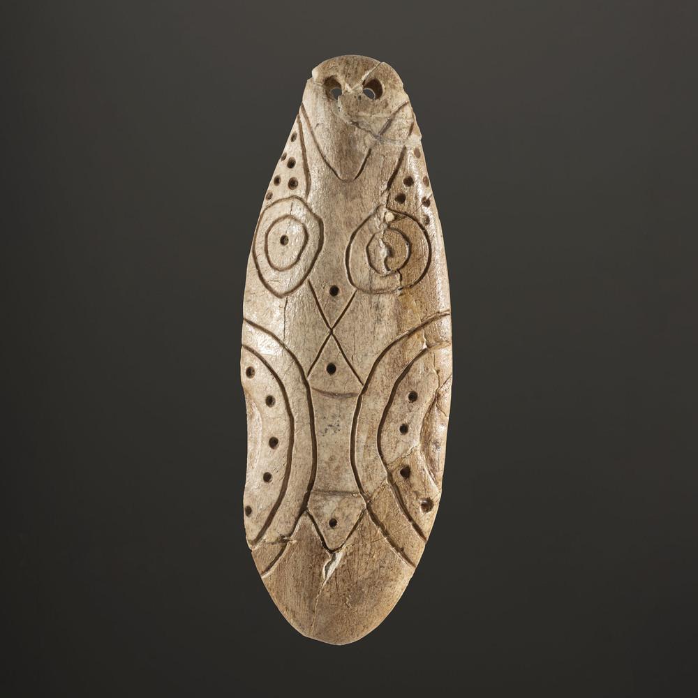 An Engraved Bone Pendant, 3-3/4 in.: Archaic Period, 8000-500 B.C. Catoma Creek, Montgomery County, Alabama length 3-3/4 in. Collection History: Gerber Collection Number: AG.SB339