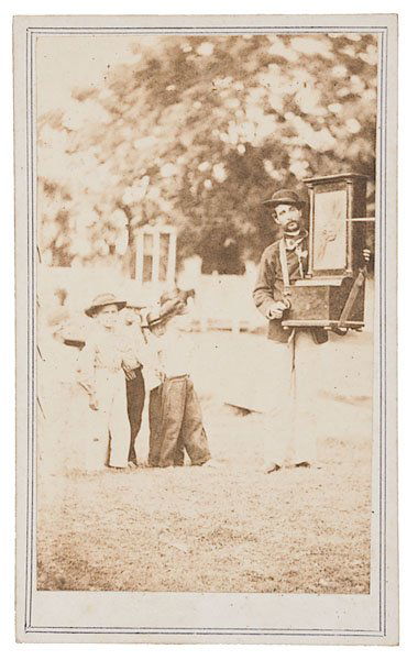 CDV of Civil War Era Organ Grinder, : CDV of Civil War Era Organ Grinder, by McPherson & Oliver, Baton Rouge, showing a civilian organ grinder playing for an audience of small boys, context unknown.