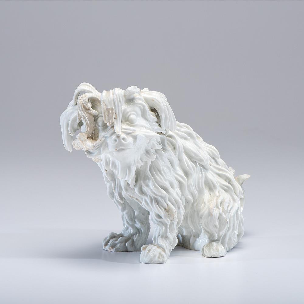 A Meissen White Porcelain Bolognese Spaniel: German, 19th Century with blue underglaze crossed sword mark near tail. Height 8 inches. Provenance: Property of Anne Romanoff Ilyinsky